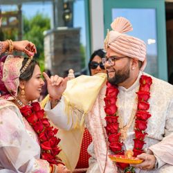 Los Angeles Videographers - Los Angeles wedding photographer captures a traditional ceremony moment with bride and groom in garlands.