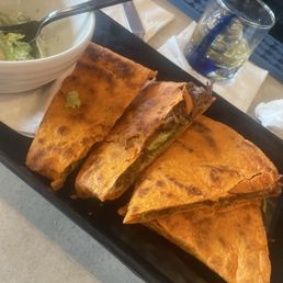 Korean brisket quesadillas. Half eaten Caesar salad. Korean brisket quesadillas. Half eaten Caesar salad.