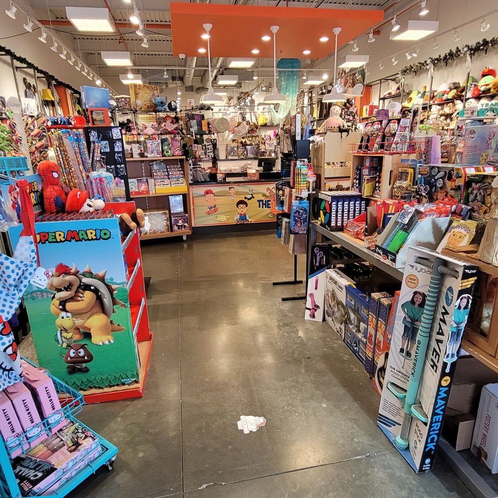 Entrance of store surrounded by childhood toys Entrance of store surrounded by childhood toys