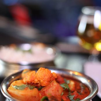 Zuzu Momo - a bowl of stew and a glass of beer - Indian Near Me - Everett, Massachusetts