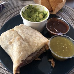 Carnitas burrito with chips and guacamole. So good!