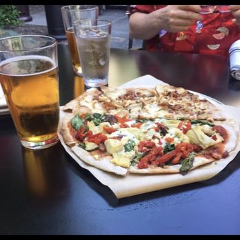 The Red Grape - Our half and half pizza. Red sauce side is Tuscan Sun and the white side is Pears And Gorgonzola sitting outside on their back deck area - Pizza Near Me - Sonoma, California The Red Grape - Our half and half pizza. Red sauce side is Tuscan Sun and the white side is Pears And Gorgonzola sitting outside on their back deck area - Pizza Near Me - Sonoma, California