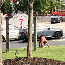 Marker 7 Coastal Grill - This dude decided to do about 30 minutes of stretching on the lawn in front of the restaurant. What ⁉