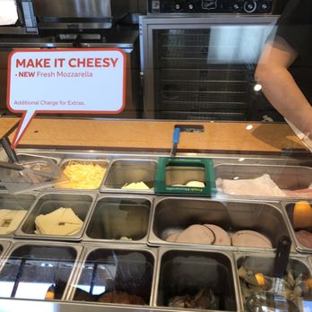 Subway - a man standing behind a counter filled with food - Sandwiches Near Me - Fresno, California