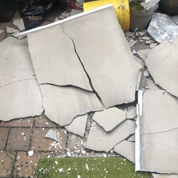 Guzzo Stucco - Large sheets of stucco that fell off rowhouse after installation by Guzzo Stucco. - Stucco Services Near Me - Vineland, New Jersey