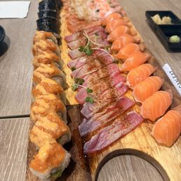 Giant salmon, tuna carpaccio, salmon nigiri, spicy tuna roll, salmon carpaccio, salmon belly, poke nachos
