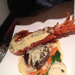 Frank's Seafood Bistro - Lovely seafood plater with mornay sauce serve on a side of steam vegetables and a slice of eye fillet..