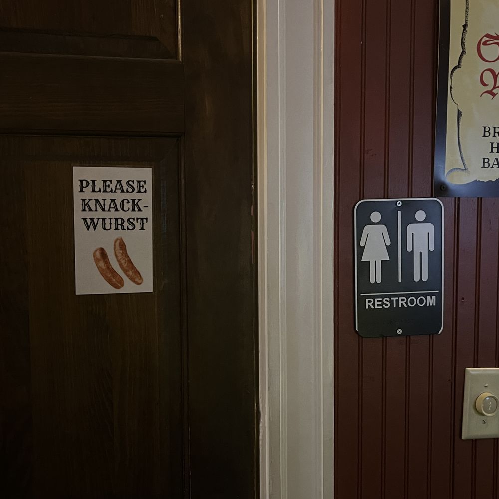 Nocturnem Draft Haus - a bathroom door with a sign on it - Bars Near Me - Bangor, Maine