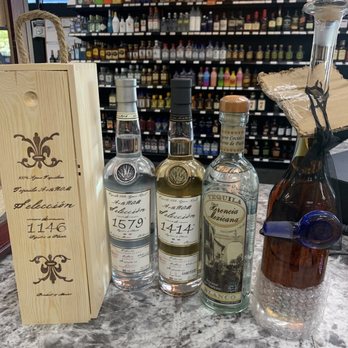 High Spirits - a variety of liquor bottles on a counter - Beer, Wine & Spirits Near Me - Evansville, Indiana