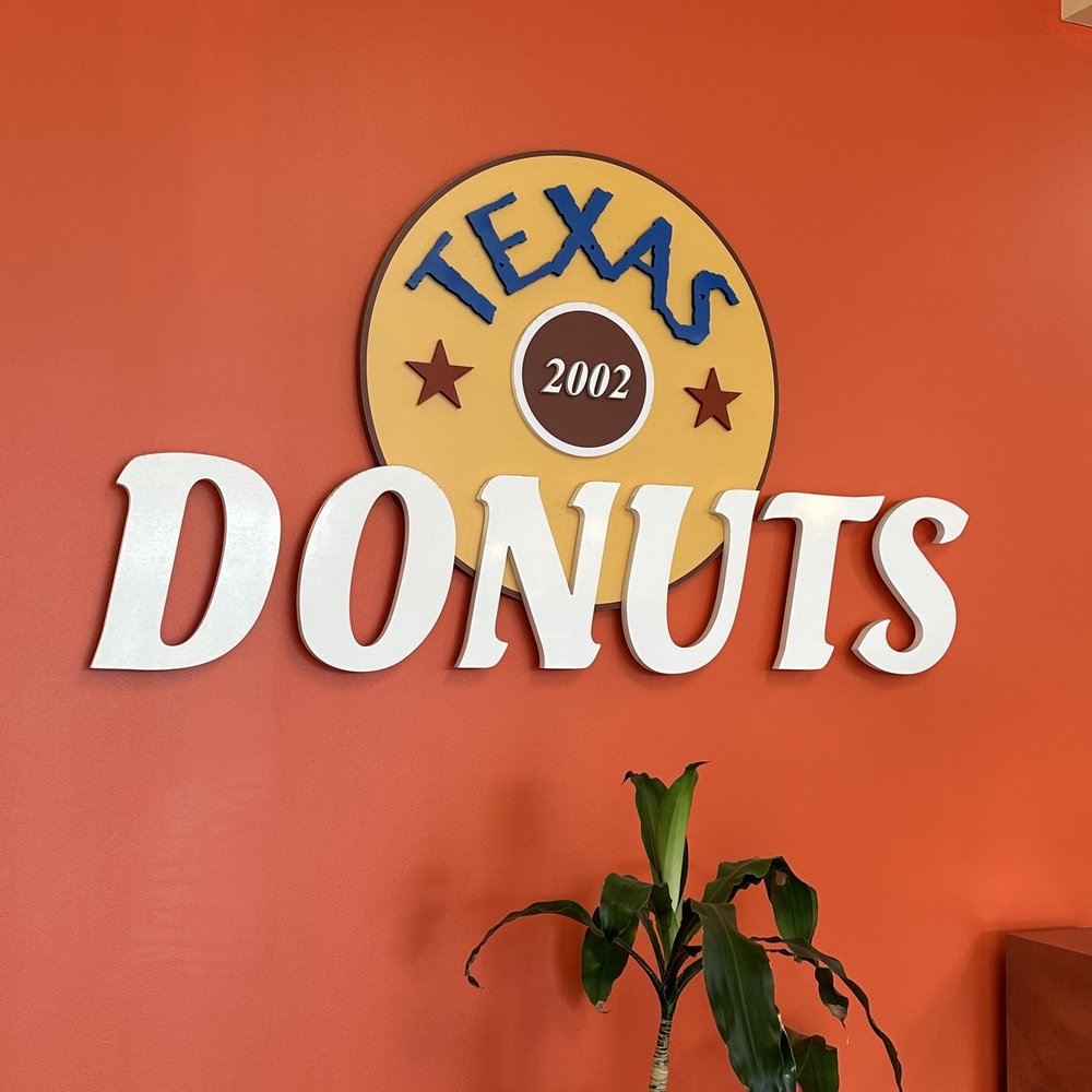 Texas Donuts - a plant in front of a sign - Donuts Near Me - Manassas, Virginia