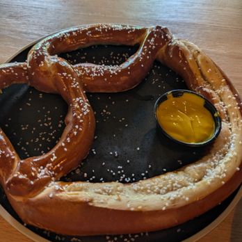 Old Mission Distilling - Soft pretzel with yellow mustard (cheese sauce available for $2 extra) - Distilleries Near Me - Traverse City, Michigan Old Mission Distilling - Soft pretzel with yellow mustard (cheese sauce available for $2 extra) - Distilleries Near Me - Traverse City, Michigan