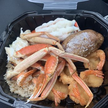 Red Lobster - Admirals feast for takeout with crab, lobster, two types of shrimp, baked potato and rice. Butter and lemon come on side. - Seafood Near Me - Saint Cloud, Minnesota