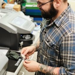 Eye Clinics of Seattle - Queen Anne - Lab tech Brandon inserts lenses in our in-house lab.