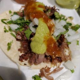 Carnitas taco with avocado salsa