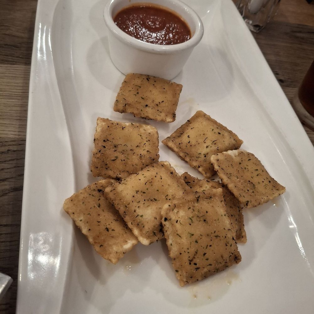La Piazza - Fried cheese ravioli.  Bland but I dipped them in the oil & spices and it was very good - Desserts Near Me - Sherman, Texas