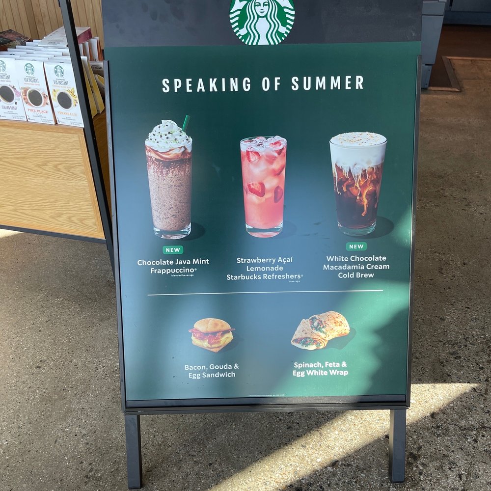 a sign with a variety of drinks a sign with a variety of drinks