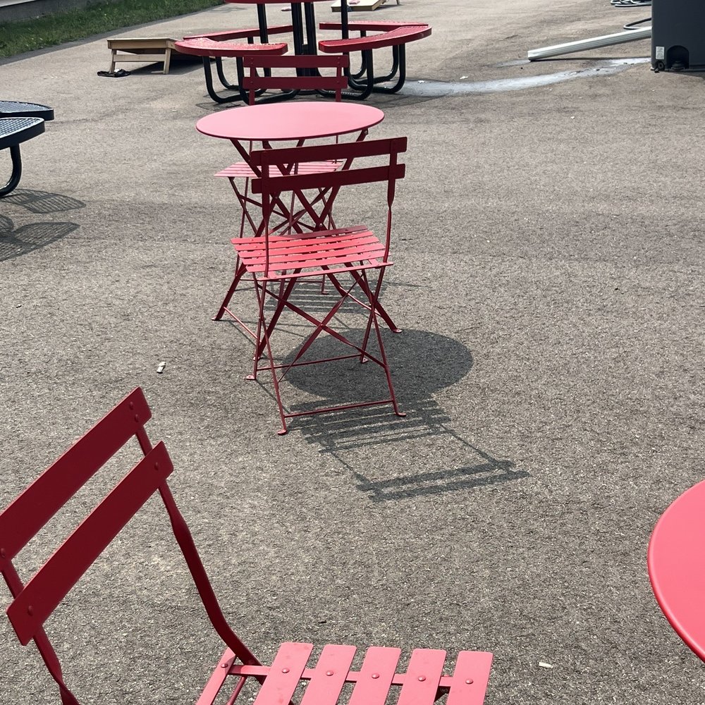 Booms Ice Cream - red chairs and tables in a parking lot - Ice Cream & Frozen Yogurt Near Me - Hugo, Minnesota