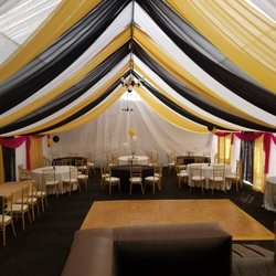 J-Ram Party Rental - Draping for a 30x50. Black event turf and gold chiavari chairs.