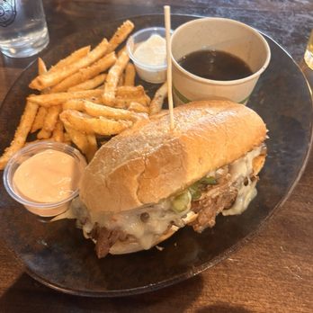 Strap Tank Brewery - Philly Cheesesteak with Fries and a too small cup of Au Jus - American Near Me - Springville, Utah Strap Tank Brewery - Philly Cheesesteak with Fries and a too small cup of Au Jus - American Near Me - Springville, Utah