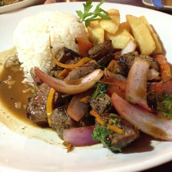 Aji Peruvian Cuisine - Lomita saltado - one of the signature dishes of Peruvian cuisine: tender bites of steak with sautéed vegetables and fries. - Peruvian Near Me - Long Beach, California