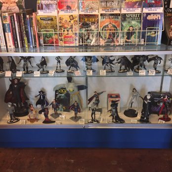 Ash Avenue Comics & Books - Statues and figure rains in a glass case. - Comic Books Near Me - Tempe, Arizona Ash Avenue Comics & Books - Statues and figure rains in a glass case. - Comic Books Near Me - Tempe, Arizona