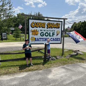Caddie Shack - two boys standing in front of a sign - Mini Golf Near Me - Canaan, Connecticut