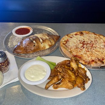 Ralph’s Zucca Pizza - from top right to bottom left: Calzone, cheese pizza and buffalo wings with ranch. - Pizza Near Me - Kennesaw, Georgia