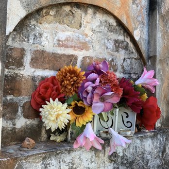 Lucky Bean Tours - Flowers on an interesting landmark grave (go on the tour and find out more)! - Historical Tours Near Me - New Orleans, Louisiana