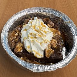 Brownie with snickers, whip cream, and caramel drizzle. Brownie with snickers, whip cream, and caramel drizzle.