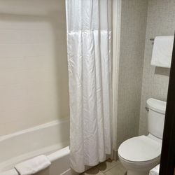 Holiday Inn Express & Suites Bishop - Tub and shower unit is very old and toilet paper dispenser is falling off the wall.