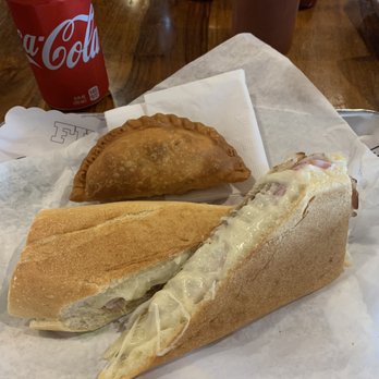 El Cubanito - Cuban sandwich with steak empanada behind it. - Cuban Near Me - Chicago, Illinois El Cubanito - Cuban sandwich with steak empanada behind it. - Cuban Near Me - Chicago, Illinois