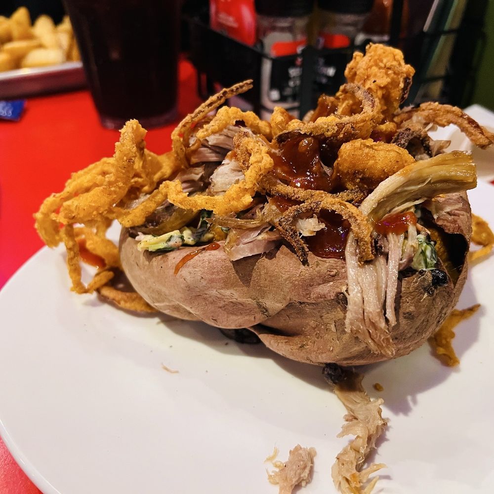 Sweet potato stuffed with pulled pork, crispy onion rings, Cole slaw. I did opt out of the chipotle bbq and substituted for honey bbq.