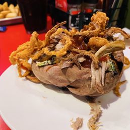 Sweet potato stuffed with pulled pork, crispy onion rings, Cole slaw. I did opt out of the chipotle bbq and substituted for honey bbq. Sweet potato stuffed with pulled pork, crispy onion rings, Cole slaw. I did opt out of the chipotle bbq and substituted for honey bbq.