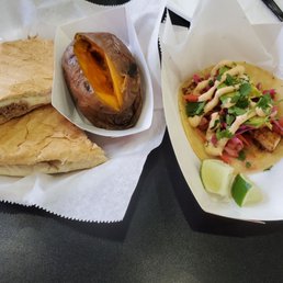Cubano sandwich with a side of sweet potato and Mahi Mahi fish taco Cubano sandwich with a side of sweet potato and Mahi Mahi fish taco
