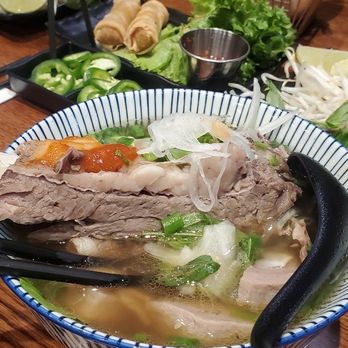 Pho Broth - The challenger pho with bone in rib eye fried veggie rolls and Parmesan truffle fries - Vietnamese Near Me - Huntington Beach, California Pho Broth - The challenger pho with bone in rib eye fried veggie rolls and Parmesan truffle fries - Vietnamese Near Me - Huntington Beach, California
