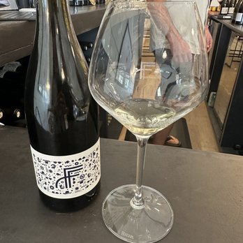 Ferris & Fletch Wine - a glass of wine and a bottle of wine - Wine Bars Near Me - Fredericksburg, Texas