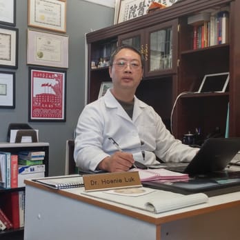 Hoenie Luk, L.Ac., Ph.D. - Dr. Hoenie Luk at his desk - Acupuncture Near Me - San Bruno, California Hoenie Luk, L.Ac., Ph.D. - Dr. Hoenie Luk at his desk - Acupuncture Near Me - San Bruno, California