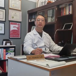 Hoenie Luk, L.Ac., Ph.D. - Dr. Hoenie Luk at his desk