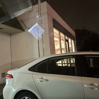 Cops - a white car parked in front of a building - Donuts Near Me - North York, Ontario