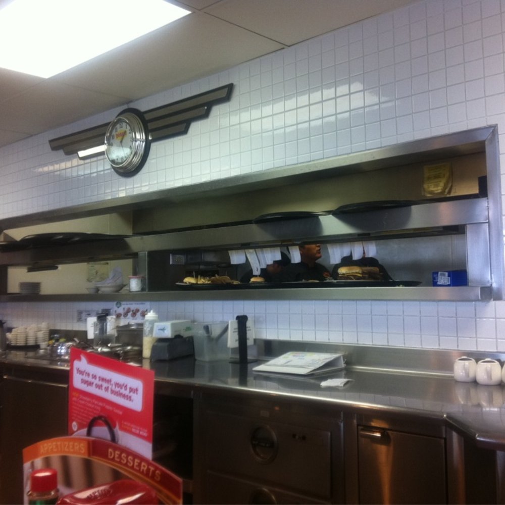 a kitchen with a clock on the wall a kitchen with a clock on the wall