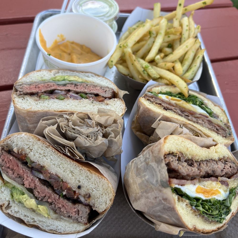 Gott's St. Helena - Texas Avocado Burger (left) abd California Burger (right) with garlic fries and a side of cheese - Burgers Near Me - Saint Helena, California Gott's St. Helena - Texas Avocado Burger (left) abd California Burger (right) with garlic fries and a side of cheese - Burgers Near Me - Saint Helena, California