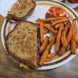 Reuban sandwich ( yes I took a few bites) and Sweet Potato Fries (yes I had already eaten few) Reuban sandwich ( yes I took a few bites) and Sweet Potato Fries (yes I had already eaten few)