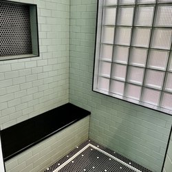 Alpha Cabinetry - Detail of walk in shower, floor, glass brick window, bench and shampoo niche
