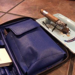 a blue leather case with a cigar on it a blue leather case with a cigar on it