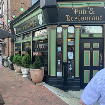 Rosie Connolly's - a man walking past a pub and restaurant - Pubs Near Me - Richmond, Virginia