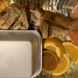 a plate of fish and orange slices a plate of fish and orange slices