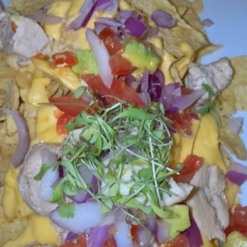 Chicharrón - Close up of the nachos trying to show yall the fake cheese and the vegetables barely being cut and the chicken even looks weird. - Puerto Rican Near Me - San Juan, Puerto Rico Chicharrón - Close up of the nachos trying to show yall the fake cheese and the vegetables barely being cut and the chicken even looks weird. - Puerto Rican Near Me - San Juan, Puerto Rico
