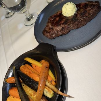 Donovan's Meatery - 12oz Prime NY Strip, Garlic Herb Butter, Sautéed Tri-Color Carrots - Steakhouses Near Me - Riverview, Florida