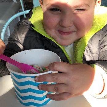 Sweet Waves - a young boy eating a bowl of cereal - Ice Cream & Frozen Yogurt Near Me - Mashpee, Massachusetts