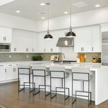 Favero Construction - a kitchen with white cabinets and stainless steel appliances - General Contractors Near Me - Los Angeles, California Favero Construction - a kitchen with white cabinets and stainless steel appliances - General Contractors Near Me - Los Angeles, California